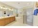 Spacious bathroom featuring a double sink vanity, soaking tub, and glass-enclosed shower at 20370 Grazie Pl, Venice, FL 34293