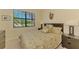 Bedroom with tropical-themed decor, a queen bed and dark wood furnishings at 20370 Grazie Pl, Venice, FL 34293