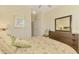Bright bedroom with a large dresser, a mirror, and a charming accent chair at 20370 Grazie Pl, Venice, FL 34293