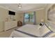 Comfortable bedroom featuring a serene lake view, soft carpeting, and neutral paint at 20370 Grazie Pl, Venice, FL 34293
