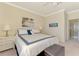 Relaxing bedroom featuring neutral walls, soft carpeting, and ample natural light at 20370 Grazie Pl, Venice, FL 34293