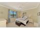 Bright bedroom with a lake view, featuring a comfortable bed and neutral decor at 20370 Grazie Pl, Venice, FL 34293