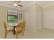 Cozy dining area featuring a round table, wicker chairs, and a bright window overlooking the exterior at 20370 Grazie Pl, Venice, FL 34293