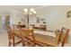 Traditional dining room with chandelier and wooden table, adjacent to kitchen, great for entertaining at 20370 Grazie Pl, Venice, FL 34293