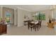 Comfortable dining room view featuring front door, dining table, and bright window at 20370 Grazie Pl, Venice, FL 34293