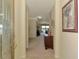Inviting foyer with view to living area and waterfront through large sliding glass doors at 20370 Grazie Pl, Venice, FL 34293