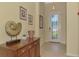 Inviting foyer with elegant decor, lovely tile floor, and decorative glass front door at 20370 Grazie Pl, Venice, FL 34293