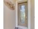 Beautiful stained-glass front door showcasing a modern handle, decorative trim, and a small welcome mat at 20370 Grazie Pl, Venice, FL 34293