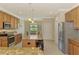 Updated kitchen featuring granite counters, stainless steel appliances, island and adjacent breakfast nook at 20370 Grazie Pl, Venice, FL 34293