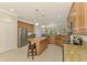 Spacious kitchen with a large island, stainless steel appliances, granite countertops and open layout at 20370 Grazie Pl, Venice, FL 34293