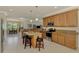 Spacious kitchen with granite countertops, stainless steel appliances, and a central island with seating at 20370 Grazie Pl, Venice, FL 34293