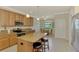 Kitchen with granite counters, stainless appliances, kitchen island with breakfast bar and eat-in nook at 20370 Grazie Pl, Venice, FL 34293