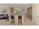Open concept kitchen and bar top seating area boasts granite counters and stainless steel appliances at 20370 Grazie Pl, Venice, FL 34293