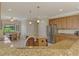 Spacious kitchen boasts an island, granite counters, pendant lighting, and breakfast nook at 20370 Grazie Pl, Venice, FL 34293