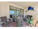 Outdoor lanai with seating and views of the water, palm trees, and lush greenery at 20370 Grazie Pl, Venice, FL 34293