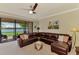 Comfortable living room with sliding glass door to screened lanai and peaceful water views at 20370 Grazie Pl, Venice, FL 34293