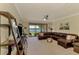 Comfortable living room featuring a large leather sofa and stunning waterfront view at 20370 Grazie Pl, Venice, FL 34293