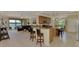 Open-concept living space with bar seating and gorgeous waterfront views from sliding glass doors at 20370 Grazie Pl, Venice, FL 34293