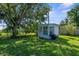 Backyard features a shed and large green space at 2185 Park Rd, Venice, FL 34293