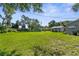 Expansive backyard featuring a lush lawn and a separate storage shed at 2185 Park Rd, Venice, FL 34293