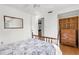 Bedroom with a wooden bed frame, ceiling fan, wooden dresser, and a decorative mirror at 2185 Park Rd, Venice, FL 34293