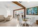 Bright dining area features a glass table, and is open to the kitchen and living space at 2185 Park Rd, Venice, FL 34293