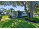 Inviting single-story home with a manicured lawn and lush landscaping at 2185 Park Rd, Venice, FL 34293