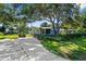 Charming home with a well-maintained lawn and mature trees providing ample shade at 2185 Park Rd, Venice, FL 34293