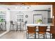 Bright kitchen with white cabinetry, modern appliances, breakfast bar, and dining nook for casual meals at 2185 Park Rd, Venice, FL 34293