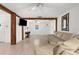 Bright living area with a vintage sewing table, white floors and walls, and exposed beams at 2185 Park Rd, Venice, FL 34293