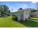 Backyard shed surrounded by lush greenery providing extra storage space at 2185 Park Rd, Venice, FL 34293