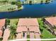 Enjoy an aerial view of a serene lake and the homes nestled along its banks at 23527 Awabuki # 202, Venice, FL 34293