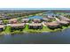 Community aerial view overlooking a lake and other homes with beautiful landscaping at 23527 Awabuki # 202, Venice, FL 34293