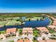 Enjoy an aerial view of a lush golf course, serene lake and well landscaped properties at 23527 Awabuki # 202, Venice, FL 34293
