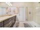 Stylish bathroom showcasing a vanity with double sinks, a walk-in shower, and tile flooring at 23527 Awabuki # 202, Venice, FL 34293