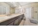 Elegant bathroom featuring a double sink vanity, modern fixtures, and a glass-enclosed walk-in shower at 23527 Awabuki # 202, Venice, FL 34293