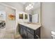 Bathroom with modern vanity, large mirror, and neutral color scheme at 23527 Awabuki # 202, Venice, FL 34293