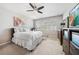 Well-lit bedroom with a comfortable bed, ceiling fan, and ample natural light streaming through the windows at 23527 Awabuki # 202, Venice, FL 34293