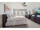 Bright bedroom featuring a ceiling fan, large windows, and neutral decor with a comfortable bed at 23527 Awabuki # 202, Venice, FL 34293