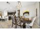 Charming dining area adjacent to a kitchen featuring modern light fixtures and neutral decor at 23527 Awabuki # 202, Venice, FL 34293