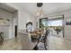 Well-appointed dining area with modern lighting, stylish chairs, table setting and seamless access to a balcony at 23527 Awabuki # 202, Venice, FL 34293