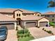 Stunning multi-story home featuring brick driveways, a tile roof and manicured landscaping under a clear blue sky at 23527 Awabuki # 202, Venice, FL 34293