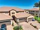 Stunning two-story home features a tile roof, three-car garage, and a well-maintained brick driveway at 23527 Awabuki # 202, Venice, FL 34293