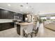 Modern kitchen with dark wood cabinets, a large island with seating, and stainless steel appliances at 23527 Awabuki # 202, Venice, FL 34293