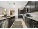 Modern kitchen featuring granite countertops, stainless steel appliances, and dark wood cabinetry at 23527 Awabuki # 202, Venice, FL 34293