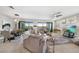 Open-concept living and dining area featuring balcony access and comfortable seating arrangements at 23527 Awabuki # 202, Venice, FL 34293
