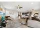 Expansive living room with tile floors, comfortable seating, modern decor, and seamless flow to dining area at 23527 Awabuki # 202, Venice, FL 34293
