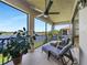 Tranquil screened patio with chaise lounges, a view of the lake, and ample space for outdoor enjoyment at 23527 Awabuki # 202, Venice, FL 34293