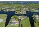Beautiful aerial view of waterfront homes with lush landscaping and private docks at 24339 Matias Ln, Punta Gorda, FL 33955