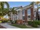 Classic city hall building with brick exterior, white columns, and manicured landscaping at 24339 Matias Ln, Punta Gorda, FL 33955